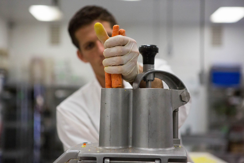 A scientist juicing carrots