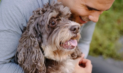A man holding a dog