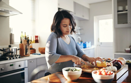 A woman making food in a kitchen
