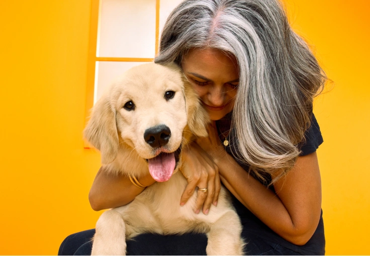A woman holding her dog